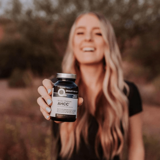 Bailey holding Quality of Life AHCC supplement
